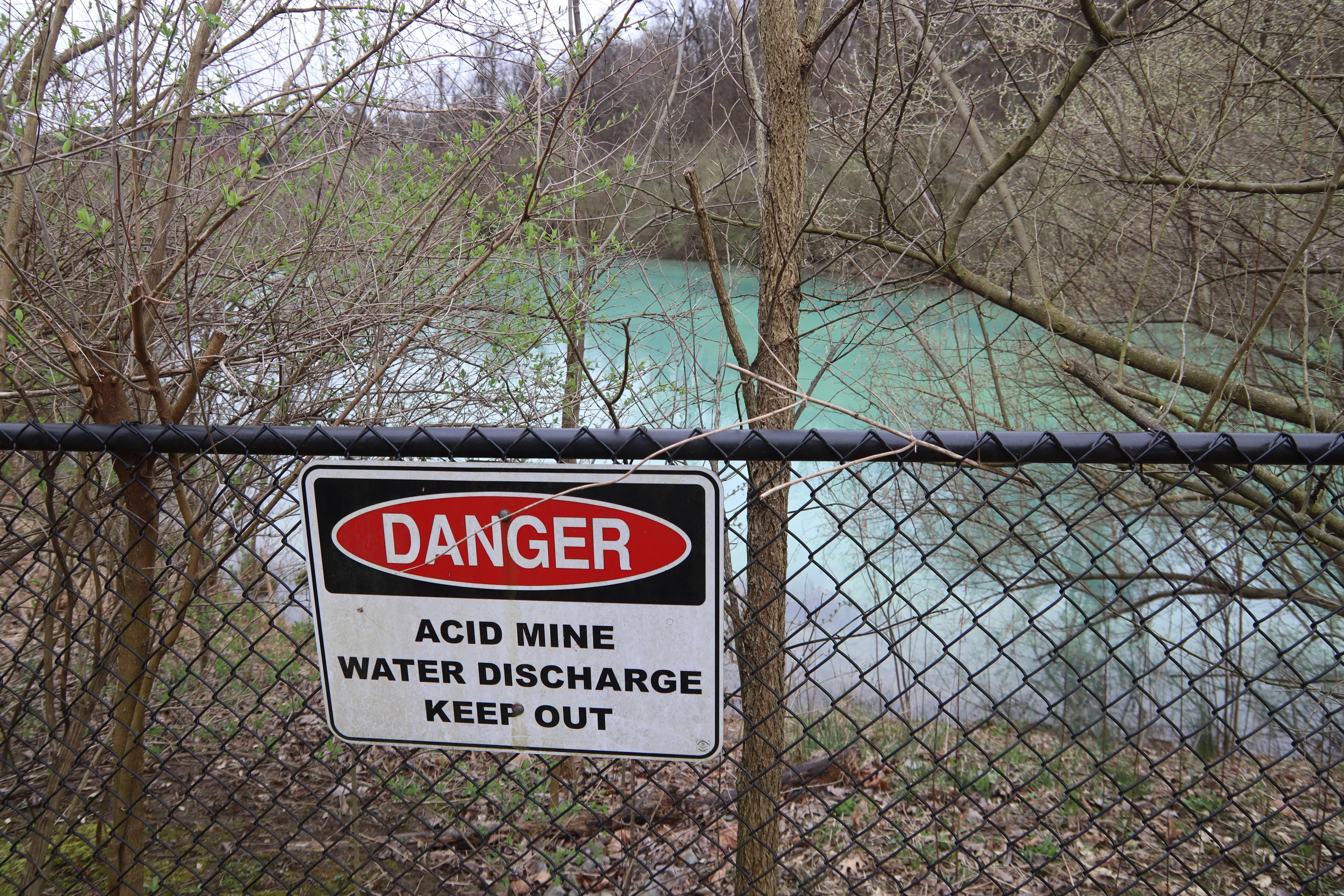 The blue lagoon in the background, with the sign: Danger, Keep out